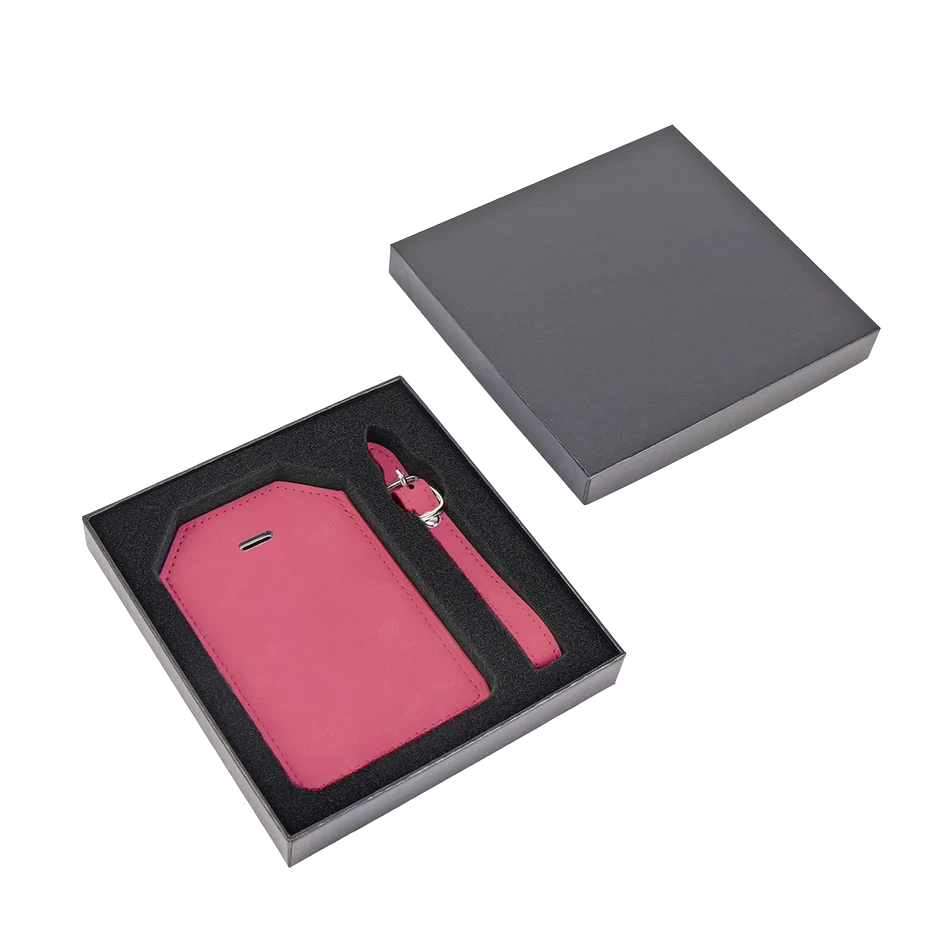 Close-up of personalized pink vegan leather luggage tag with custom engraving