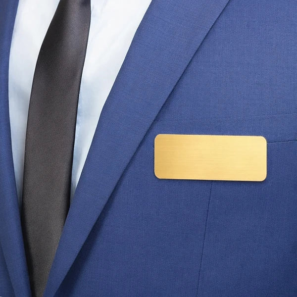 Gold metallic nametag with personalized engraved name and title on the front surface